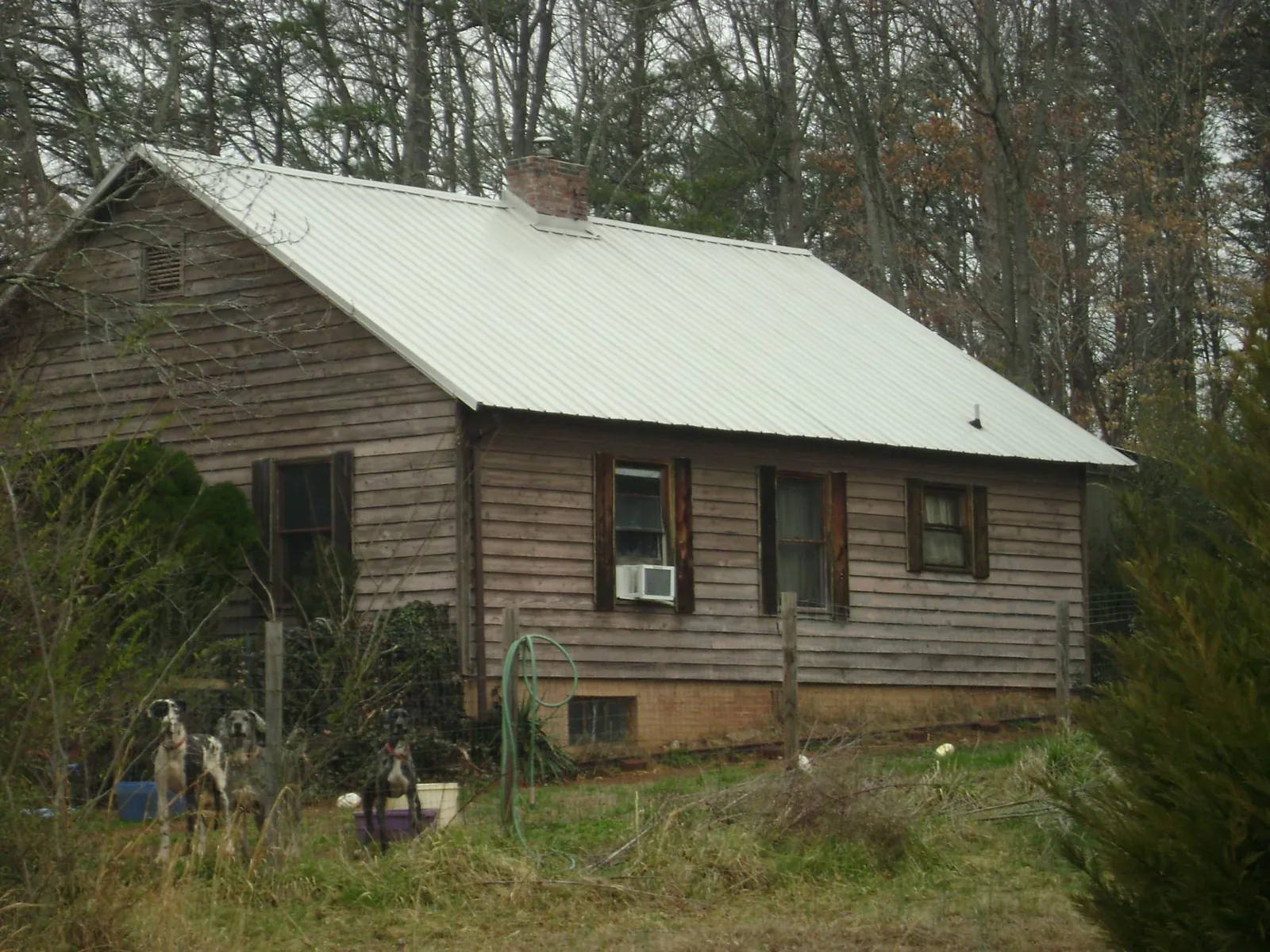 White metal roof on an old wood sided farmhouse, from a Metal Roof Installation job in Lenni
